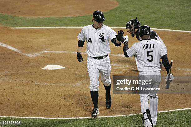 Joe Crede of the Chicago White Sox is congratulated after hitting a home run during game 1 of the World Series against the Houston Astros at US...