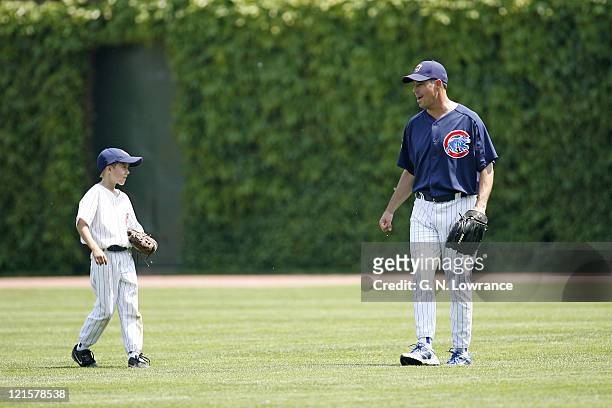Braves pitcher Greg Maddux on the field with his son prior to action between the Atlanta Braves and Chicago Cubs at Wrigley Field in Chicago,...