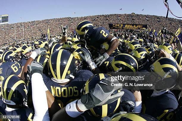 Players for the Michigan Wolverines huddle up together prior to a game against the Ohio State Buckeyes at Michigan Stadium in Ann Arbor, Michigan on...