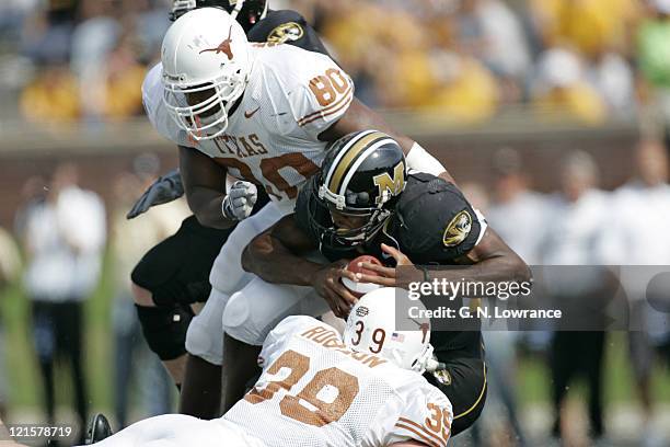 Tim Crowder and Brian Robison of the Texas Longhorns sacks Brad Smith during a game against the Missouri Tigers at Memorial Stadium in Columbia,...
