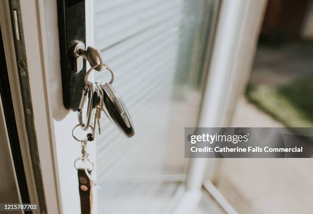 keys in a lock - cerrar con llave fotografías e imágenes de stock