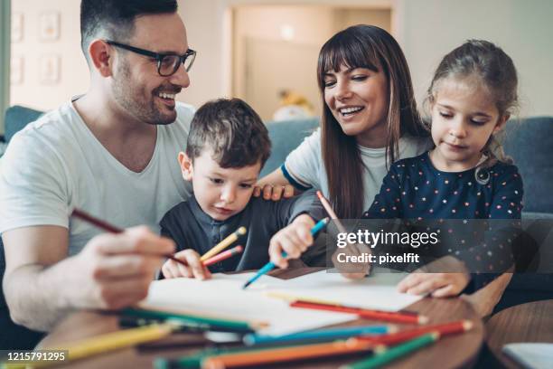 parents and children coloring pages together - stay home mom stock pictures, royalty-free photos & images