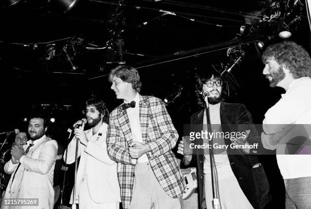 View of, from left, American actor & comedian John Belushi , musician Stephen Bishop, actor James Widdoes, film director John Landis, and musician...