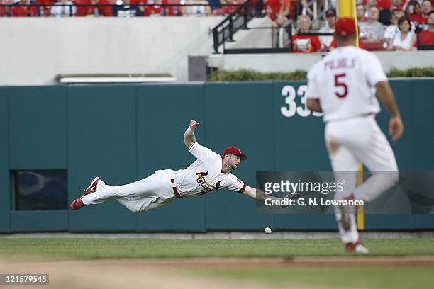Cardinal outfielder Chris Duncan goes horizontal on a ball hit by the Brewers David Bell during action between the Milwaukee Brewers and St. Louis...