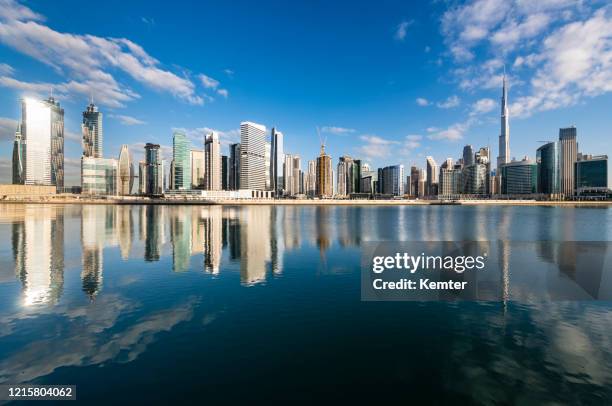 dubai skyline at the dubai creek - dubai skyline daytime stock pictures, royalty-free photos & images