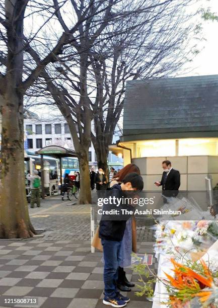 Fans of popular comedian Ken Shimura, who died of the coronavirus, offer flower at a makeshift altar installed near the Trees of Ken Shimura in front...