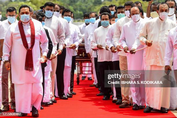 Sri Lanka's Prime Minister Mahinda Rajapaksa and former speaker of the Parliament Karu Jayasuriya attend a laying in state ceremony for late tea...