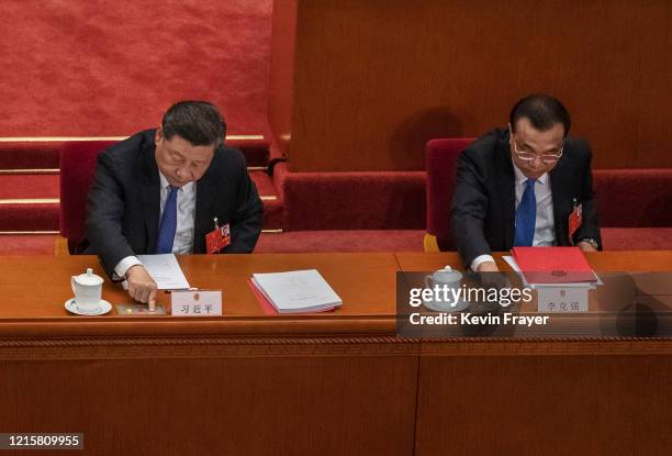 Chinese President Xi Jinping, and Premier Li Keqiang, right, press the green button as they vote on a new draft security bill for Hong Kong during...