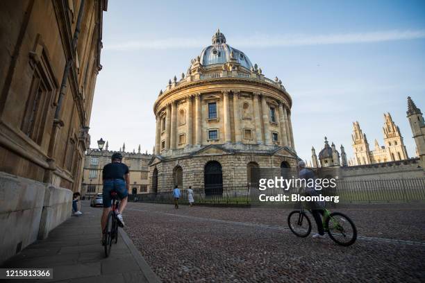 Cyclists pass the Radcliffe Camera building, part of Oxford University, in Oxford, U.K., on Wednesday, May 27, 2020. The U.K. Government's plans to...