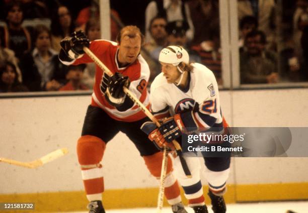 Bob Kelly of the Philadelphia Flyers tries to tie up Butch Goring of the New York Islanders during the 1980 Stanley Cup Finals in May, 1980 at the...