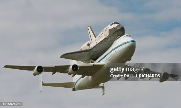The Space Shuttle Discovery takes it last ride on the back of a NASA's Boeing 747 Shuttle Carrier Aircraft, seen here on a pass over Washington,...