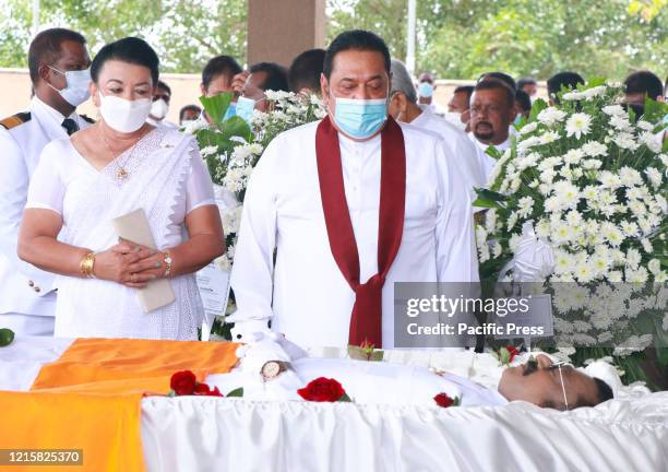 Sri Lanka's Prime Minister Mahinda Rajapaksa presents a wreath to pay his respects during the funeral of Ceylon Workers' Congress trade union leader...