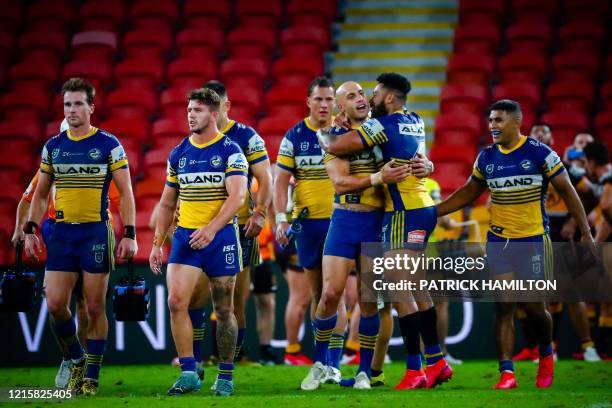 Parramatta Eels' player's Blake Ferguson is embraced by teammate Waqa Blake following the Australian Rugby League match between the Brisbane Broncos...