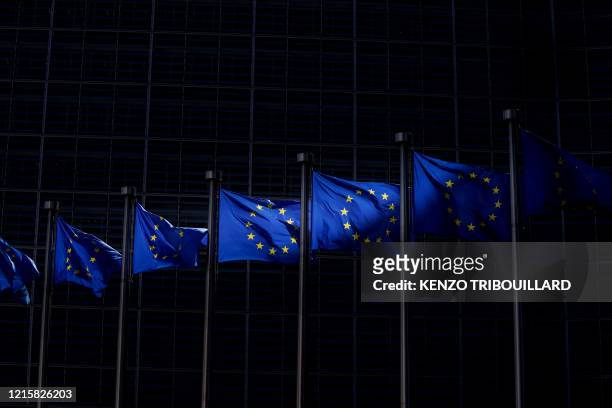 Picture taken on May 28 in Brussels shows the European Union flags fluttering in the aire outside the European Commission building in Brussels.