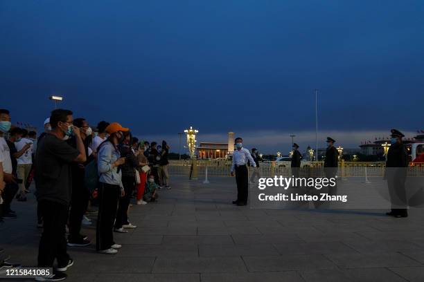 Chinese People's Liberation Army soldier guards close the way to Tiananmen Gate during the closing meeting of the third session of the 13th National...