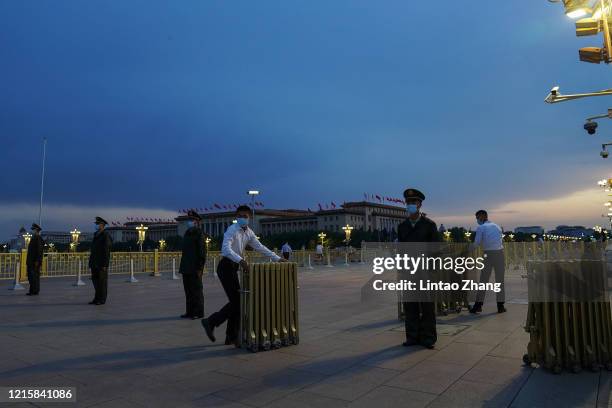 Chinese People's Liberation Army soldier guards close the way to Tiananmen Gate during the closing meeting of the third session of the 13th National...