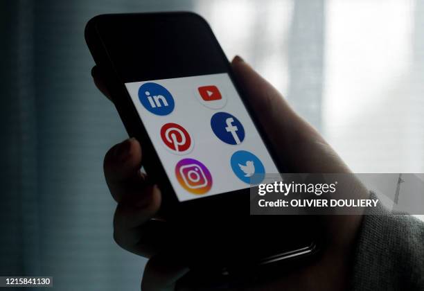 This illustration picture shows social media applications logos from Linkedin, YouTube, Pinterest, Facebook, Instagram and Twitter displayed on a...