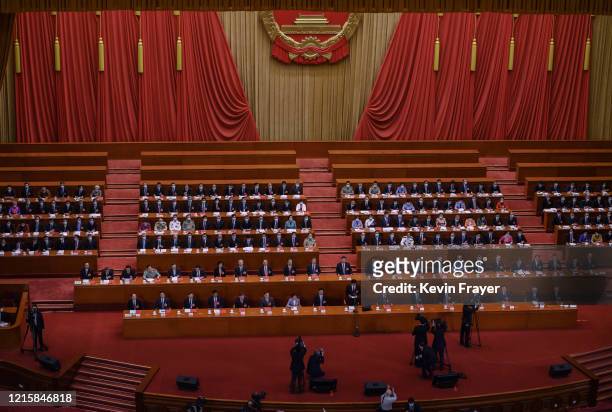 Communist Party delegates, including president Xi Jinping, center, take part in a session before voting on a new draft security bill for Hong Kong...