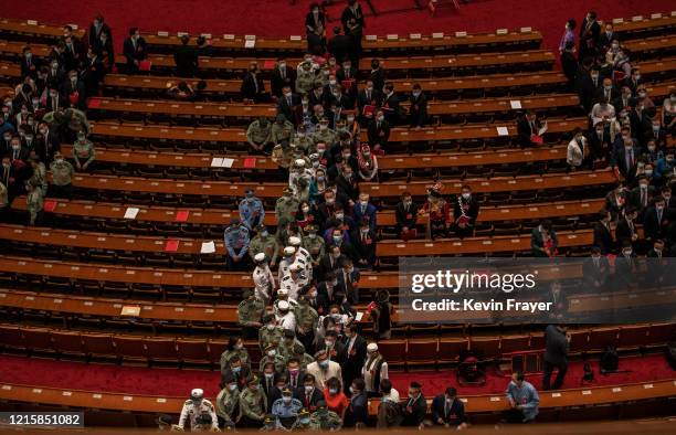 Chinese Communist Party delegates file out of the closing session of the National People's Congress at the Great Hall of the People on May 28, 2020...