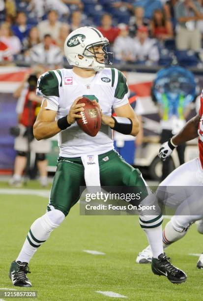 Mark Sanchez of the New York Jets drops back to pass against the New England Patriots during an NFL football on October 9, 2011 at Gillette Stadium...