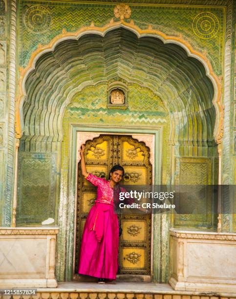 indian young woman at city palace jaipur in rajasthan state, india - udaipur india stock pictures, royalty-free photos & images