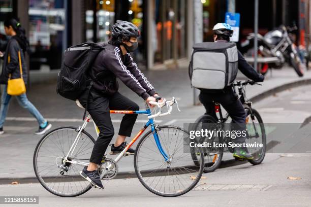 Man riding a bicycle and wearing a face mask rides along Swanston Street on 28 May, 2020 in Melbourne, Australia. While Australia's Chief Medial...