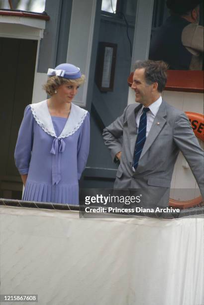 British royal Diana, Princess of Wales , wearing a lilac outfit with white trim and a lilac hat, on board the royal yacht Britannia as she visits...