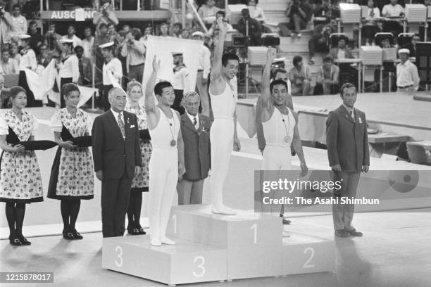 Bronze medalist Akinori Nakayama of Japan, gold medalist Sawao Kato of Japan and Silver medalist Eizo Kenmotsu of Japan celebrate on the podium at...