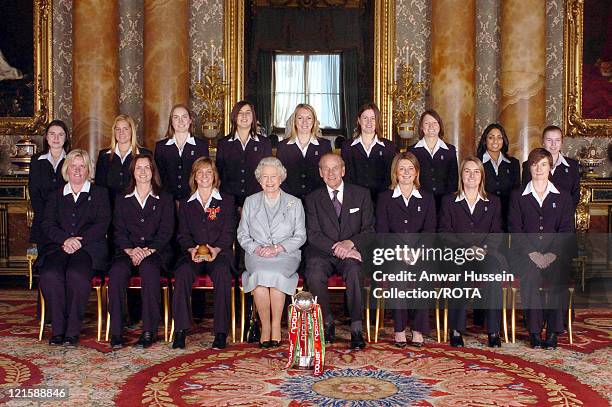Members of England's women's 2005 Ashes winning Cricket team sit with Queen Elizabeth II and the Prince Philip at Buckingham Palace on February 9,...