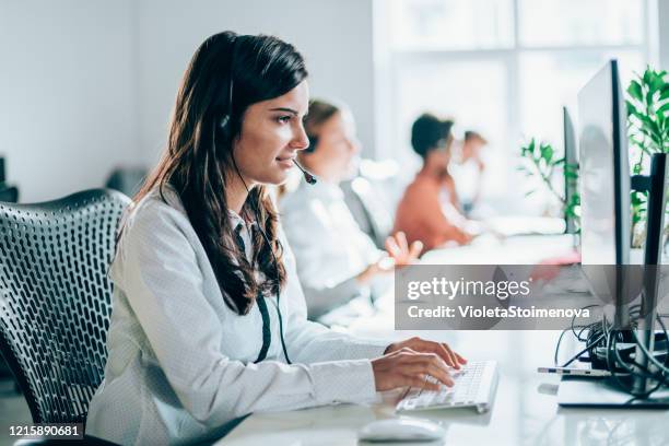 answering your call with a smile - call center agents imagens e fotografias de stock