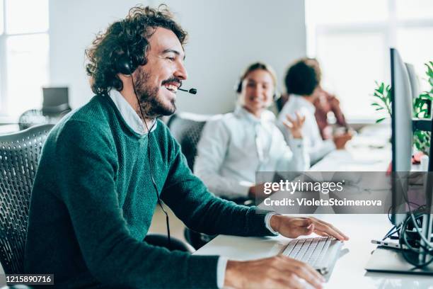 call center workers. - computer headset stock pictures, royalty-free photos & images