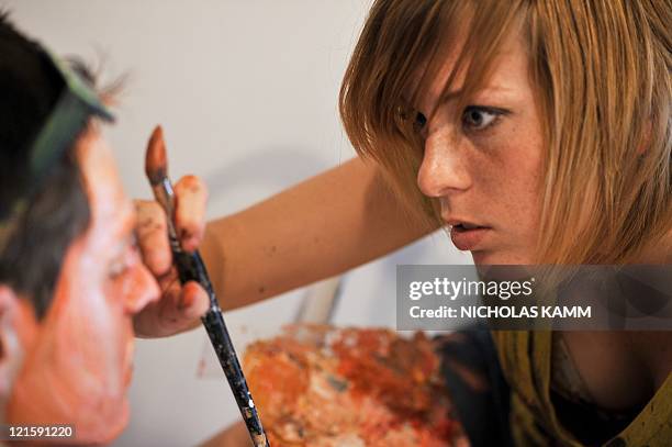 Artist Alexa Meade paints model Will Claybaugh during a performance at the Irvine Contemporary gallery in Washington on August 20, 2011. Meade paints...