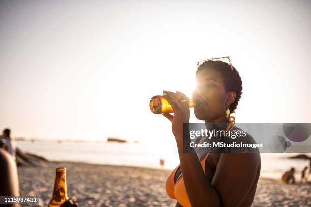 young woman having a cold beer. - cider stock pictures, royalty-free photos & images