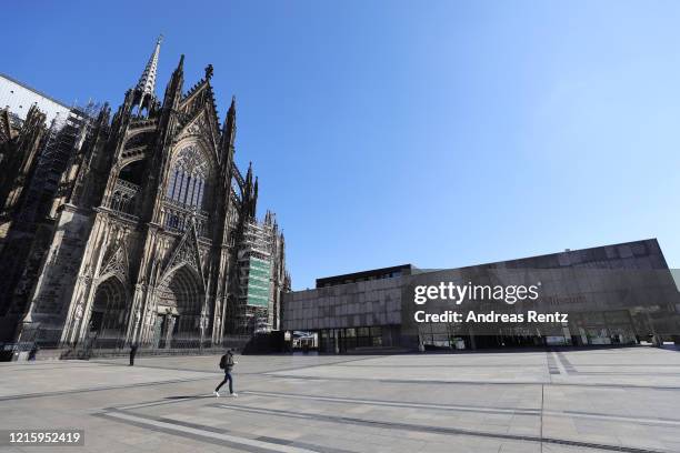 The forecourt of the Cologne Cathedral stands nearly empty where normally thousands of tourists walk daily during the coronavirus crisis on March 31,...