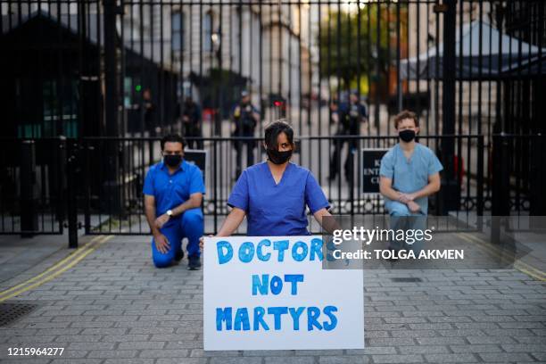 Doctors hold a silent protest during a national "clap for carers" to show thanks for the work of Britain's NHS workers and other frontline medical...