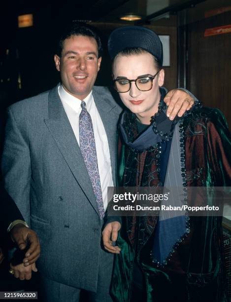 Boy George with politician and broadcaster Derek Hatton attending the premiere of the film "Moonstruck" at the Leicester Square Empire Cinema in...