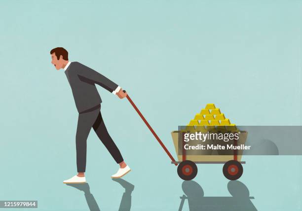 happy male investor pulling wagon full of gold bars - barren stock-grafiken, -clipart, -cartoons und -symbole