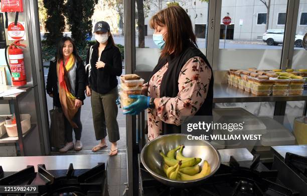 Photo taken in Melbourne on 25 May, 2020 shows Michelle Cassell , student welfare officer at the Melbourne City Institute of Education , handing free...