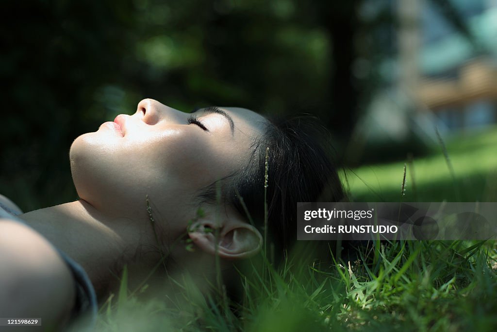 Young woman sleeping on the grass