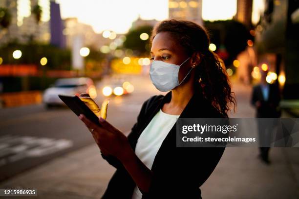 businesswoman outdoors wearing healthcare mask. - protective face mask happy stock pictures, royalty-free photos & images