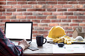 civil engineer helmet and laptop