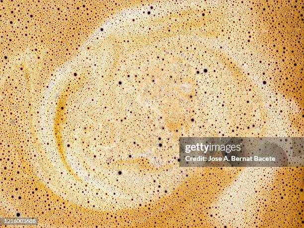 full frame of a cup of freshly made coffee with milk, backgrounds. - chocolate swirls stock-fotos und bilder