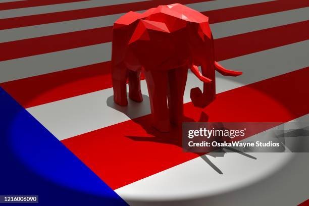 republican red elephant in spotlight on top of american flag - republican national convention stockfoto's en -beelden