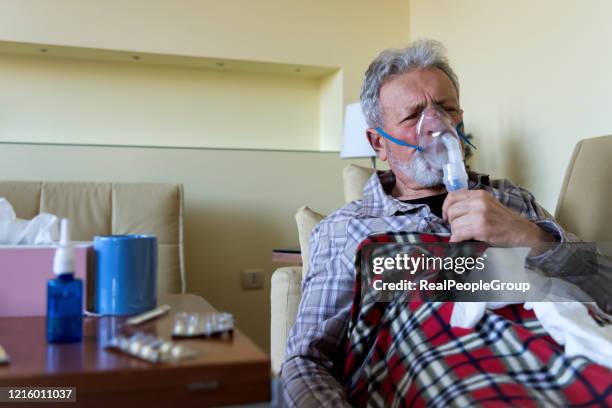 elderly patient using an inhalation mask - old cough stock pictures, royalty-free photos & images