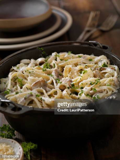 creamy mushroom one pot fettuccine alfredo - alfredo sauce stock pictures, royalty-free photos & images