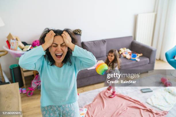 naughty girl playing with her tired mother - stressed mother stock pictures, royalty-free photos & images