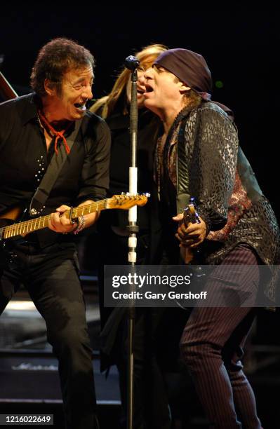 From left, American Rock musician Bruce Springsteen, on guitar, Patti Scialfa, and Steven Van Zandt , also on guitars, as they perform onstage with...