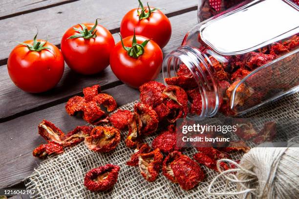 fresh tomatoes and sun dried organic tomatoes - dried stock pictures, royalty-free photos & images