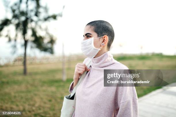 woman wearing mask to avoid infectious diseases - climate change health stock pictures, royalty-free photos & images