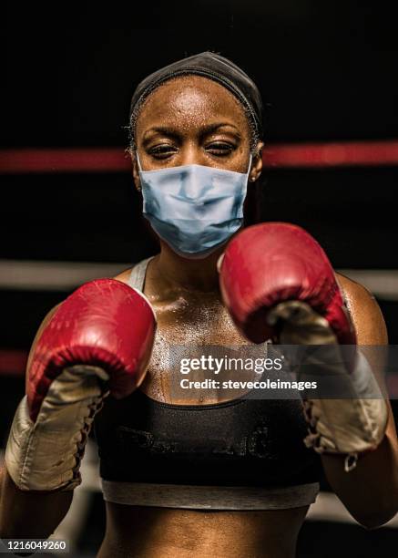 young woman boxer wearing healthcare face mask. - fighter portraits 2013 stock pictures, royalty-free photos & images